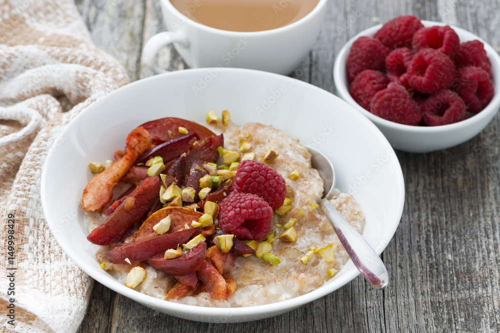 oatmeal with baked fruit for breakfast on wooden table oatmeal with baked fruit for breakfast on wooden table