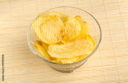 Crispy potato chips. Fast Food. Potatoes. Fatty unhealthy foods. corrugated chips