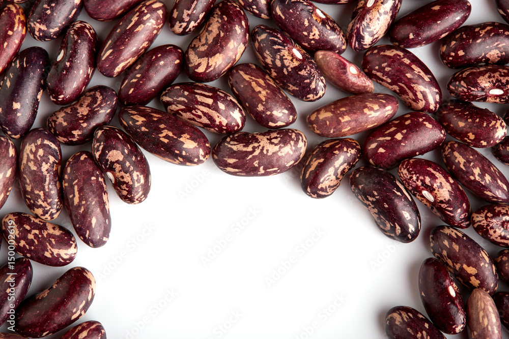 Obraz premium Dark Spotted kidney bean isolated on white background. Dark kidney bean texture background. A large bean with a subtle sweet flavor and soft texture. Beans. Proper nutrition. Vitamins. Healthy food.