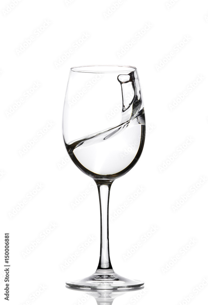 A splash of crystal clear water in a glass for wine. Water splashes. Drinking water. Alcohol