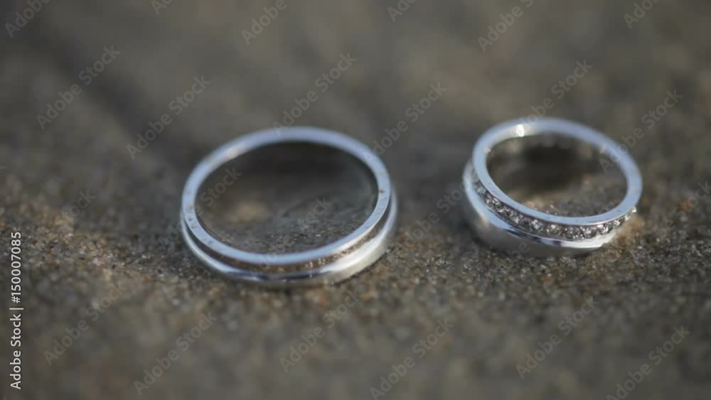 Sea surfs splashing silver wedding rings in sands Sea surfs splashing silver wedding rings in sands