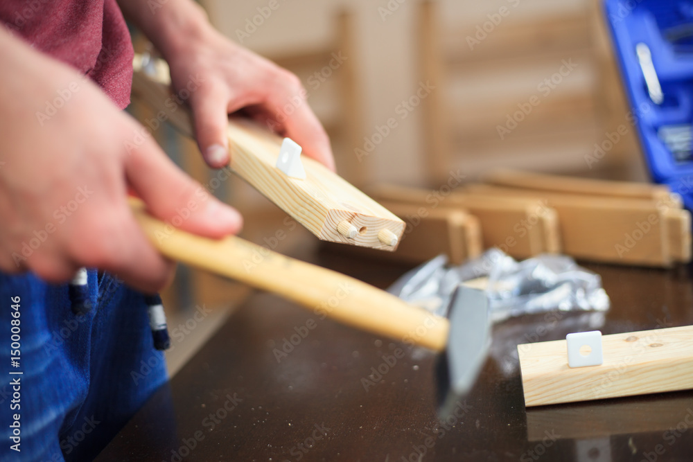 Man hands constructing a chairs with some tools, woodwork