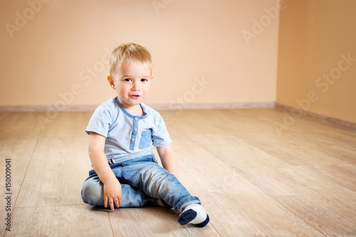 Portrait of a two years old child sitting on the floor