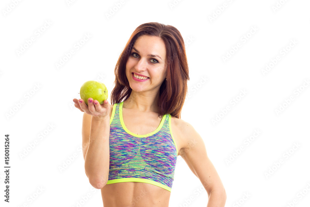 Sportive woman holding apple Sportive woman holding apple