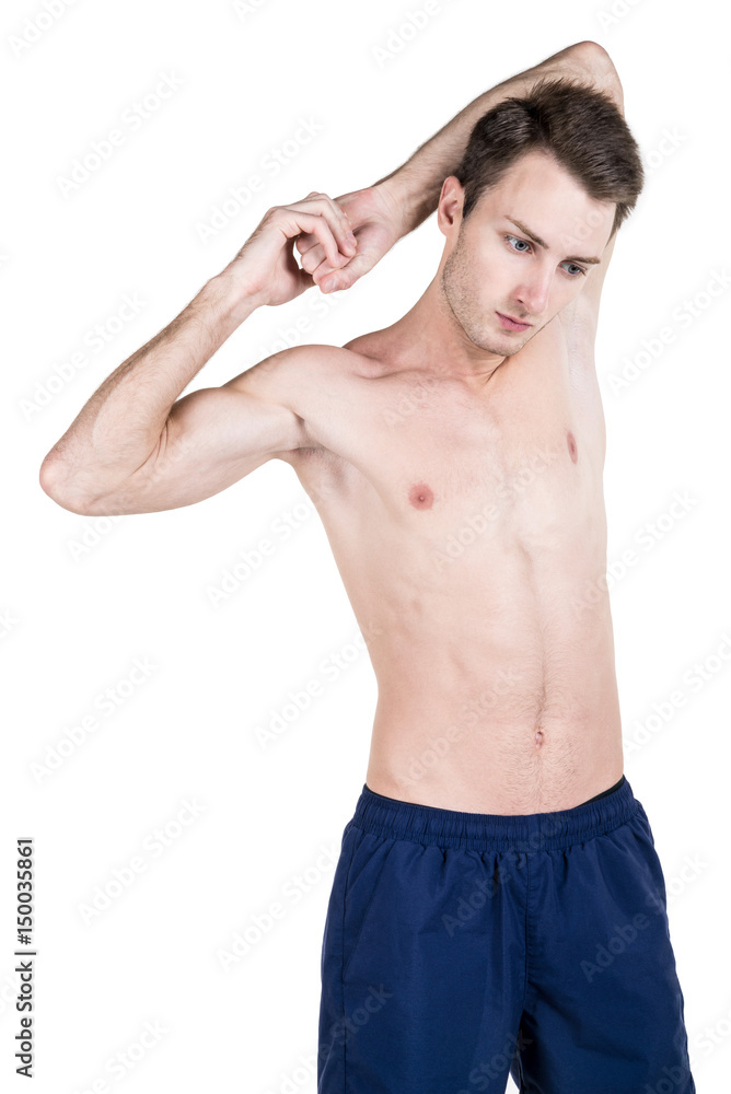 Fototapeta premium Healthy lifestyle. Portrait of a handsome guy with a sporty naked body, warming up, isolated on white background. Vertical frame