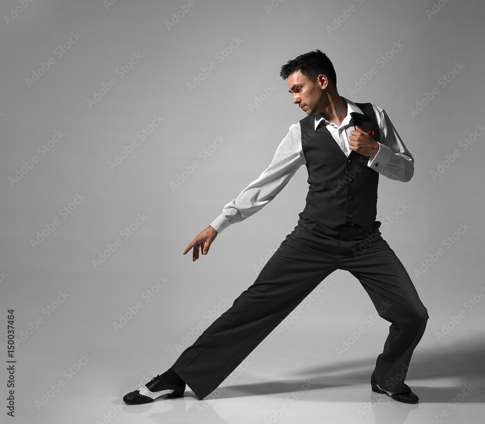 Young male professional dancer dancing in studio.