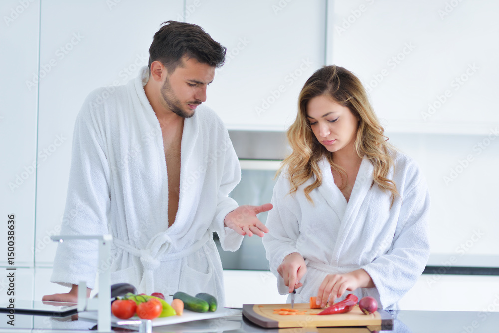 Happy couple cooking breakfast together in the kitchen Happy couple cooking breakfast together in the kitchen