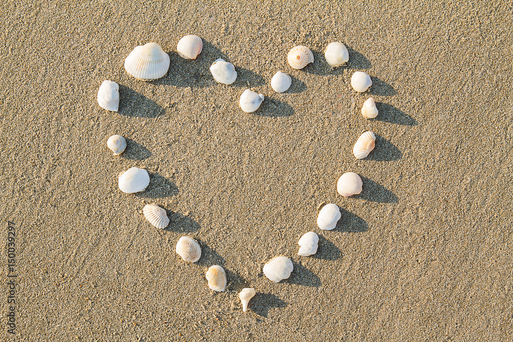 Heart shaped sea shells on the sand beach, love concept Heart shaped sea shells on the sand beach, love concept