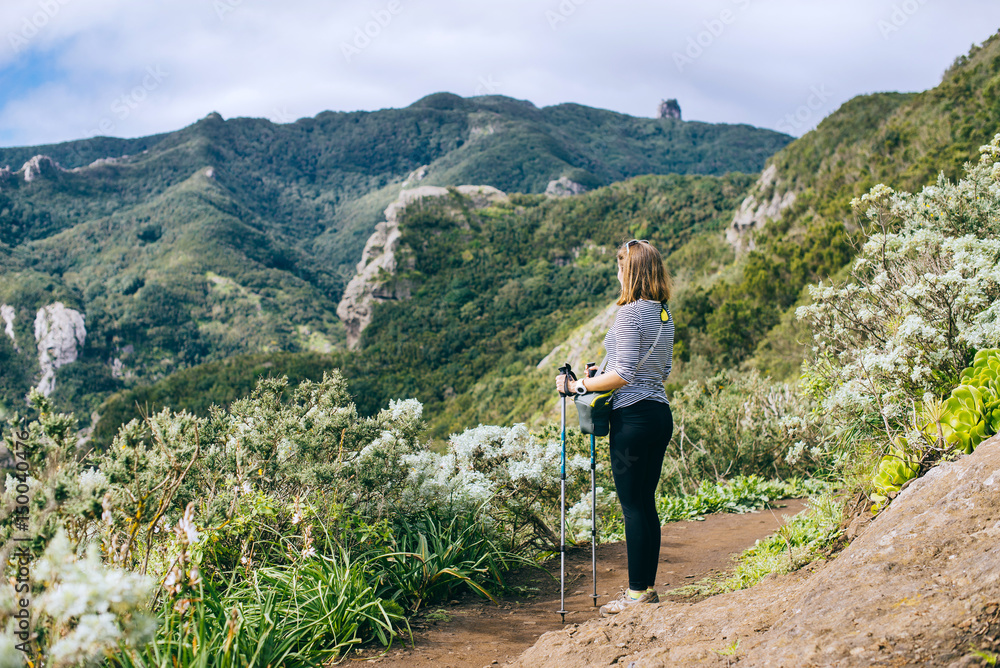 Woman leads a healthy lifestyle and walks green mountains in Spain