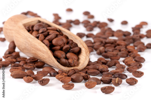 coffee beans in a wooden scoop isolated on white background