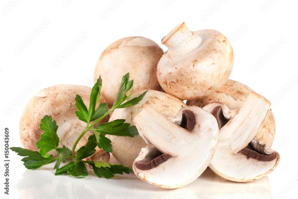 A bunch of champignon mushrooms with leaf parsley isolated on white background A bunch of champignon mushrooms with leaf parsley isolated on white background