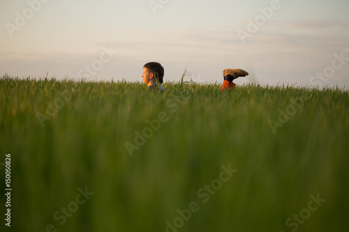 The teenager lies in the tall grass at sunset © makam1969