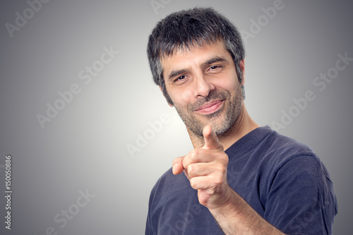 Happy man pointing with his finger photo