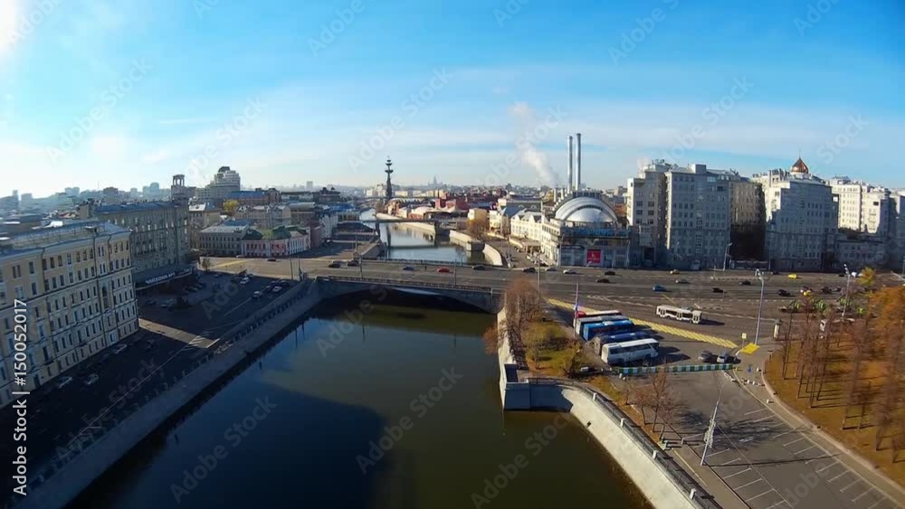 Crimea picturesque embankment bridge road traffic. Moscow river Old historical building roofs center. Peter Statue Vodootvodny Canal Smoke from pipes. Russia. Summer blue sky. Aerial above approach Crimea picturesque embankment bridge road traffic. Moscow river Old historical building roofs center. Peter Statue Vodootvodny Canal Smoke from pipes. Russia. Summer blue sky. Aerial above approach