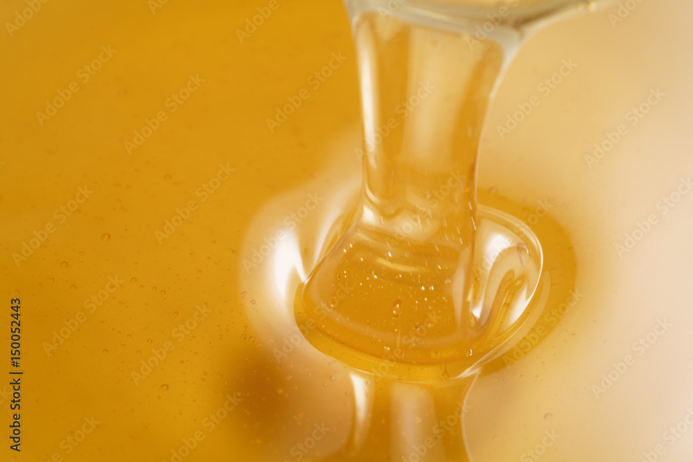 closeup of pouring organic honey with copy space, amber golden color closeup of pouring organic honey with copy space, amber golden color