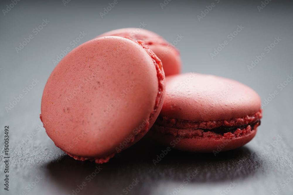 bright pink macarons on slate background, shallow focus bright pink macarons on slate background, shallow focus