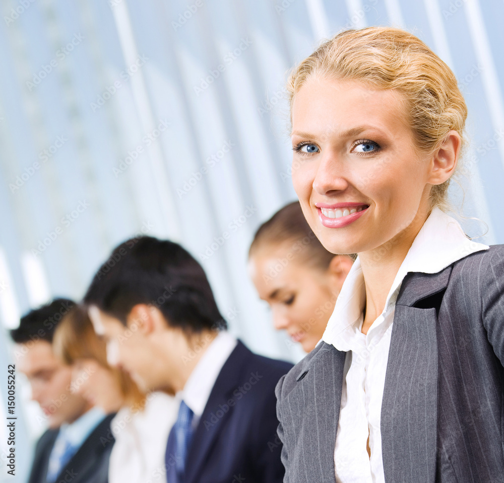 Businesswoman and colleagues, at office