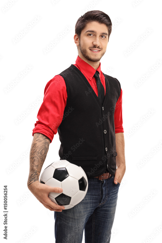 Tattooed guy holding a football and looking at the camera