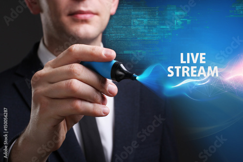 Business, Technology, Internet and network concept. Young businessman working on a virtual screen of the future and sees the inscription: Live stream
