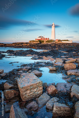 St Mary's Lighthouse in portrait / St Mary's Lighthouse on a small rocky Island, just north of Whitley Bay on the North East coast of England. A causeway submerged at high tide links to the mainland