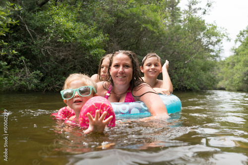 Mother and children with inflatable ring in lake, Niceville, Florida, USA photo