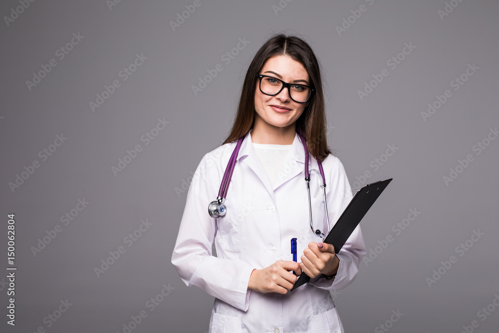 Female doctor holding a clipboard - isolated over a grey background Female doctor holding a clipboard - isolated over a grey background