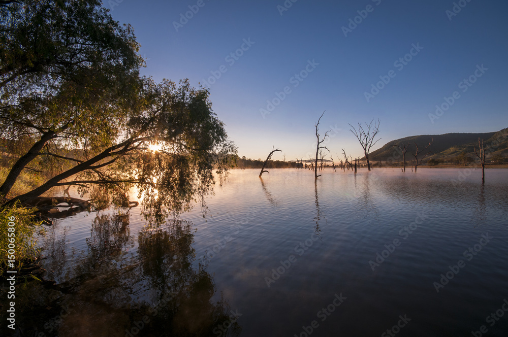 Fototapeta premium Sunrise reflections on the water