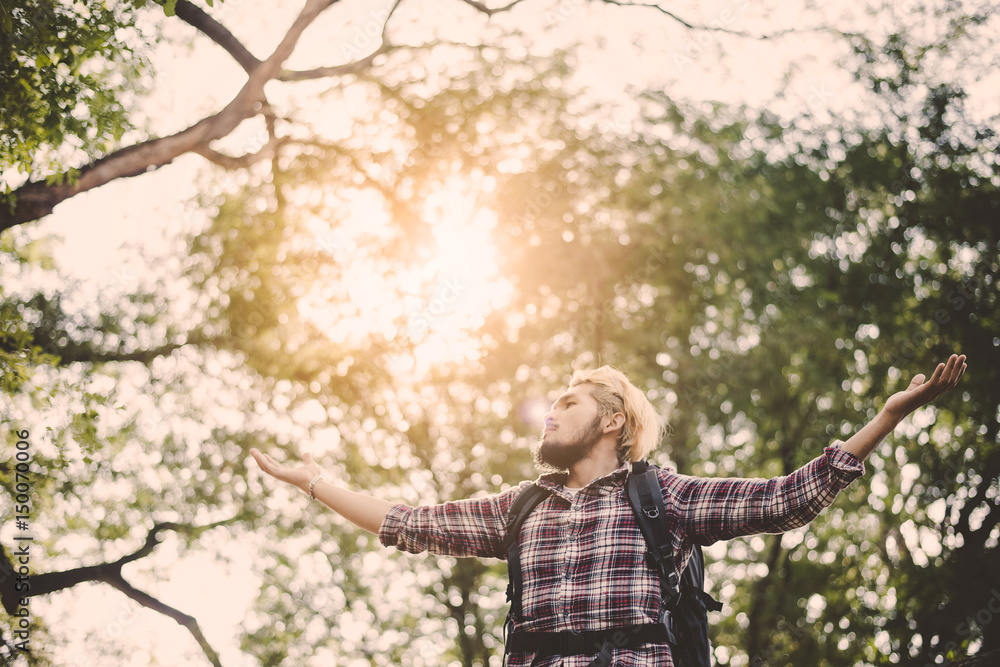 Young man sitting relax on tree in the forest. Young man sitting relax on tree in the forest.