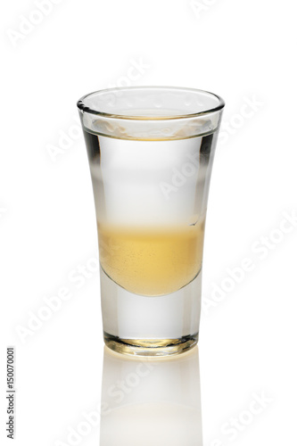 Cocktail with three layers of alcohol in shot glass isolated on white