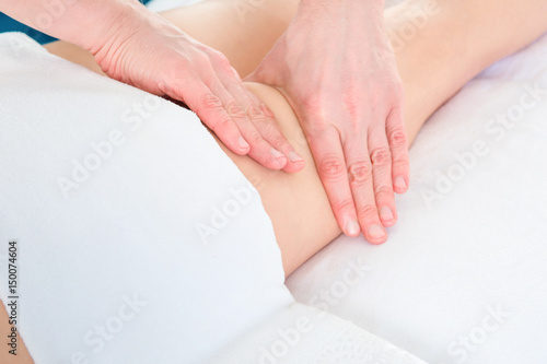 masseur makes anti-cellulite massage young woman on white background