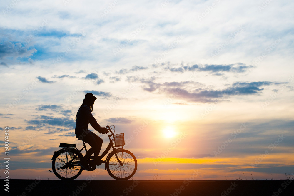 Obraz premium Silhouette, young women cycling with sunset.