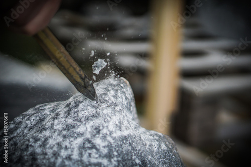 Hard Work Chiseling a Stone by Hand with Hammer and Chisel