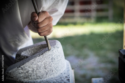 Chiseling a Stone by Hand photo