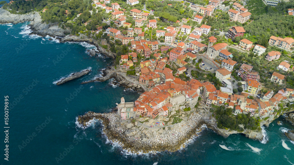 Aerial video shooting with drone on Tellaro, famous Ligurian village near the Cinqueterre, small colored houses built on the cliff by the sea