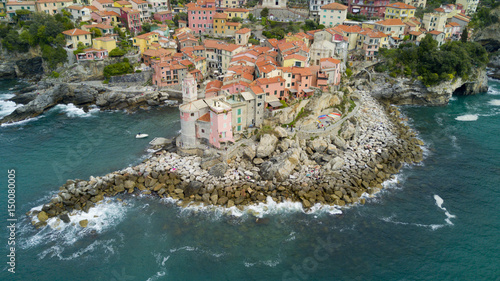 Aerial video shooting with drone on Tellaro, famous Ligurian village near the Cinqueterre, small colored houses built on the cliff by the sea