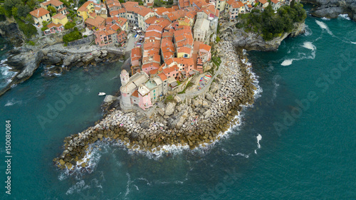 Aerial video shooting with drone on Tellaro, famous Ligurian village near the Cinqueterre, small colored houses built on the cliff by the sea