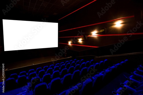 Cinema hall, movie theater, theatre with blue armchairs and white screen with copy space photo