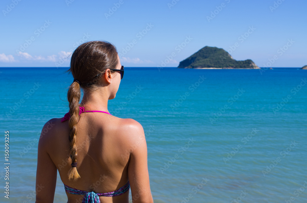 Young woman and Marathonisi island - Zakynthos, Greece