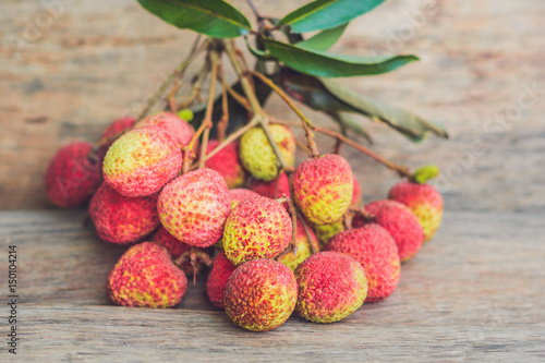 Fresh litchi fruit on an old wooden background photo