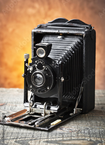 Old camera on an old background on a close-up table