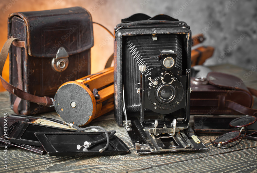 Old camera on an old background on a close-up table Old camera on an old background on a close-up table