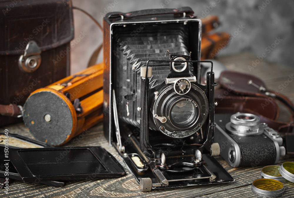 Old camera on an old background on a close-up table Old camera on an old background on a close-up table