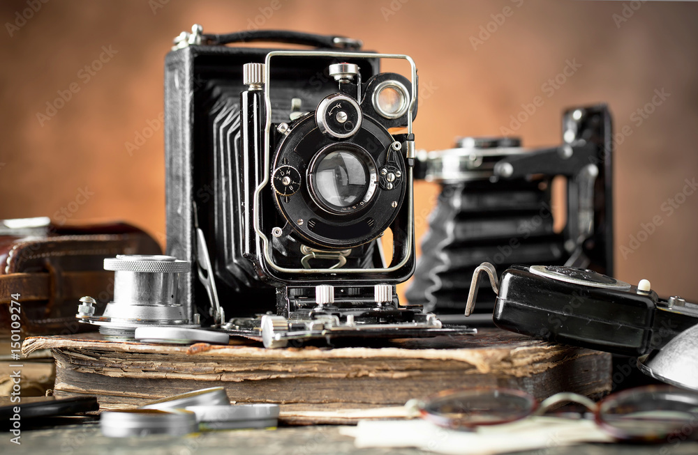 Old camera on an old background on a close-up table