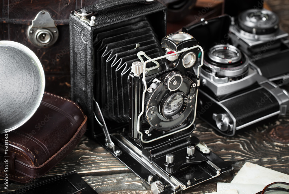 Old camera on an old background on a close-up table Old camera on an old background on a close-up table