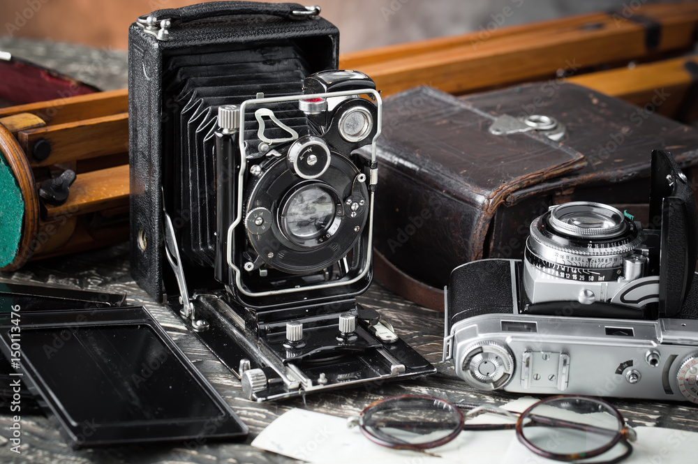 Old camera on an old background on a close-up table