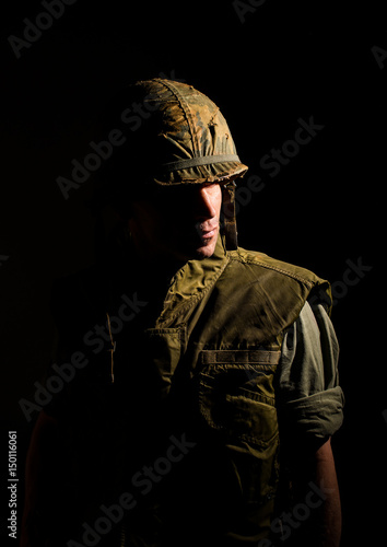 Fotografie US marine (Vietnam War) in spotlight with dramatic deep shadows.