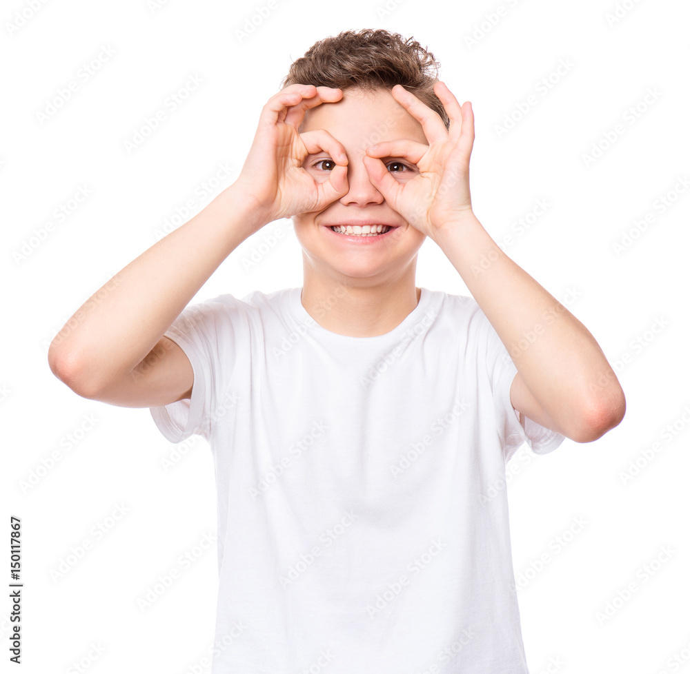 White t-shirt on teen boy. Handsome smiling child making ok gesture, isolated on a white background. Concept of childhood and fashion or advertisement design. Mock up template for design print. White t-shirt on teen boy. Handsome smiling child making ok gesture, isolated on a white background. Concept of childhood and fashion or advertisement design. Mock up template for design print.
