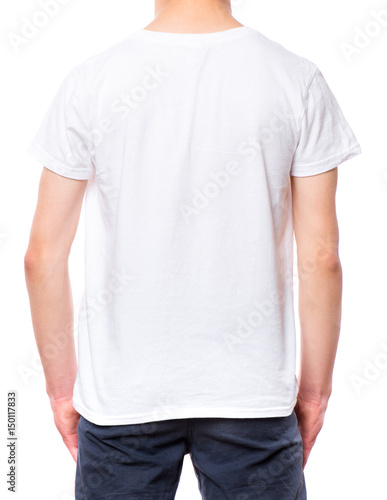 White t-shirt on teen boy. Close-up of back tshirt, isolated on a white background. Concept of childhood and fashion or advertisement design. Mock up template for design print. 