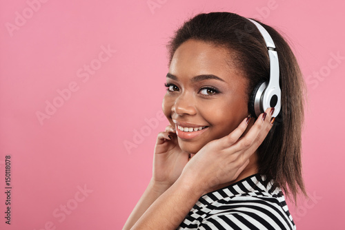 Portrait of a smiling happy afro american woman in headphones
