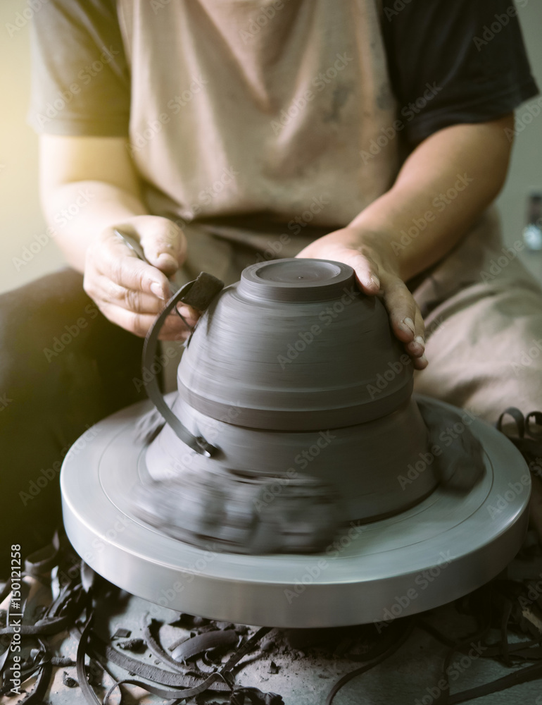 Potter making a clay pot, handmade, selective focus